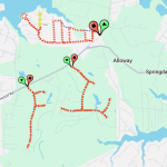 A map showing a network of red arrows and markers on a green landscape near Alloway and Springdale. Paths branch off from main roads, and various green and red pins indicate specific locations or stops along the routes.