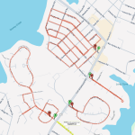 A map showing a coastal area with marked routes. Red dashed lines indicate paths along several streets, looping back near the shore. Green and red map pins are placed along the routes, denoting specific locations.