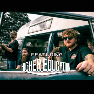 Three men are posing by a van, two sitting inside and one standing outside. The words "Featuring Higher Education" are overlaid, promoting the band. The website highereducationband.com is also visible.